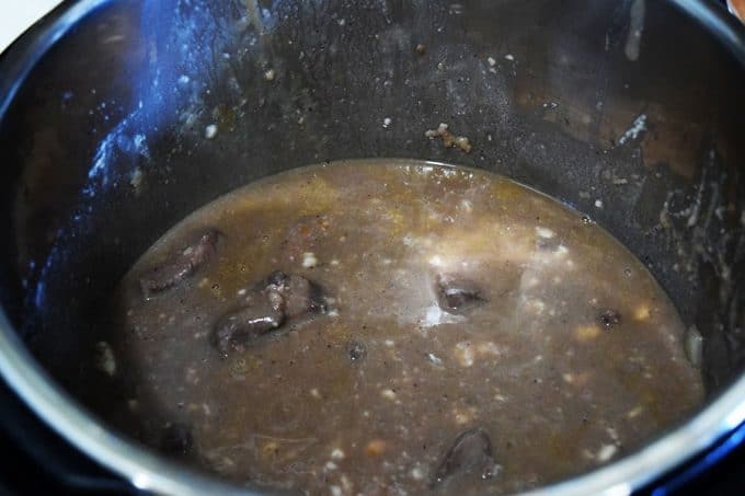 Sautéed beef tips and broth ready to be cooked in the instant pot for this pressure cooker beef tips recipe