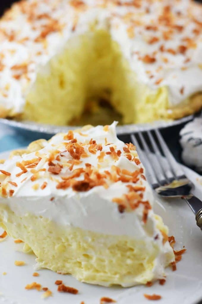 a close up of a slice of this easy coconut cream pie with toasted coconut 