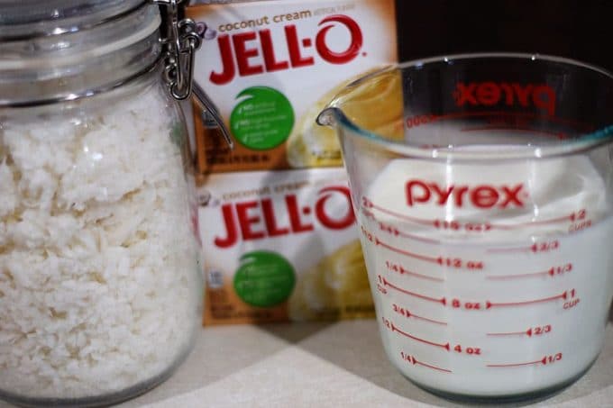 The coconut cream Jell-O, shredded coconut, and wet ingredients needed to make this easy coconut cream pie