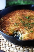 A closeup of this collard greens au gratin recipe in a black cast iron skillet