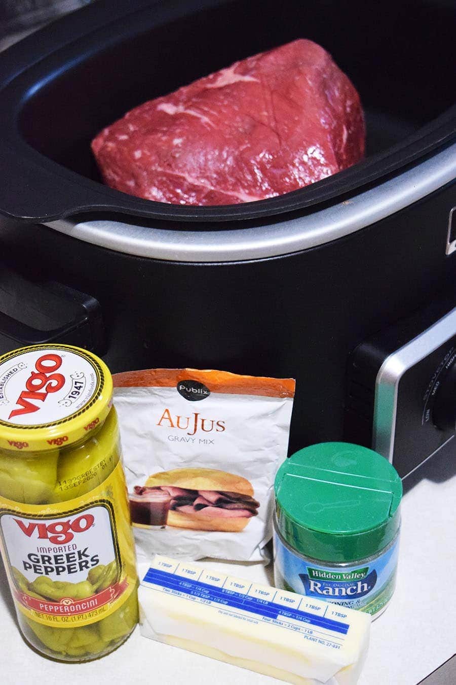 all of the ingredients needed to make this slow cooker mississippi pot roast
