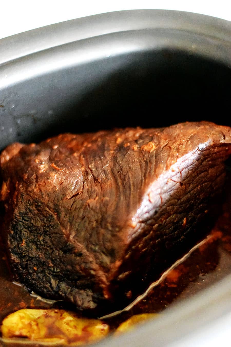 a cooked rump roast in a crock pot from this slow cooker mississippi pot roast recipe