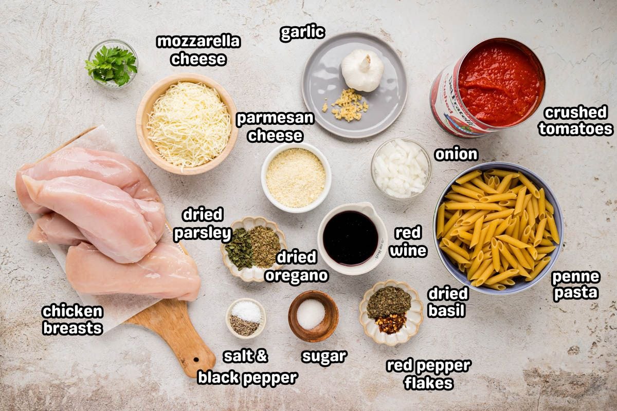 A labeled image of ingredients needed to make slow cooker chicken Parmesan pasta.