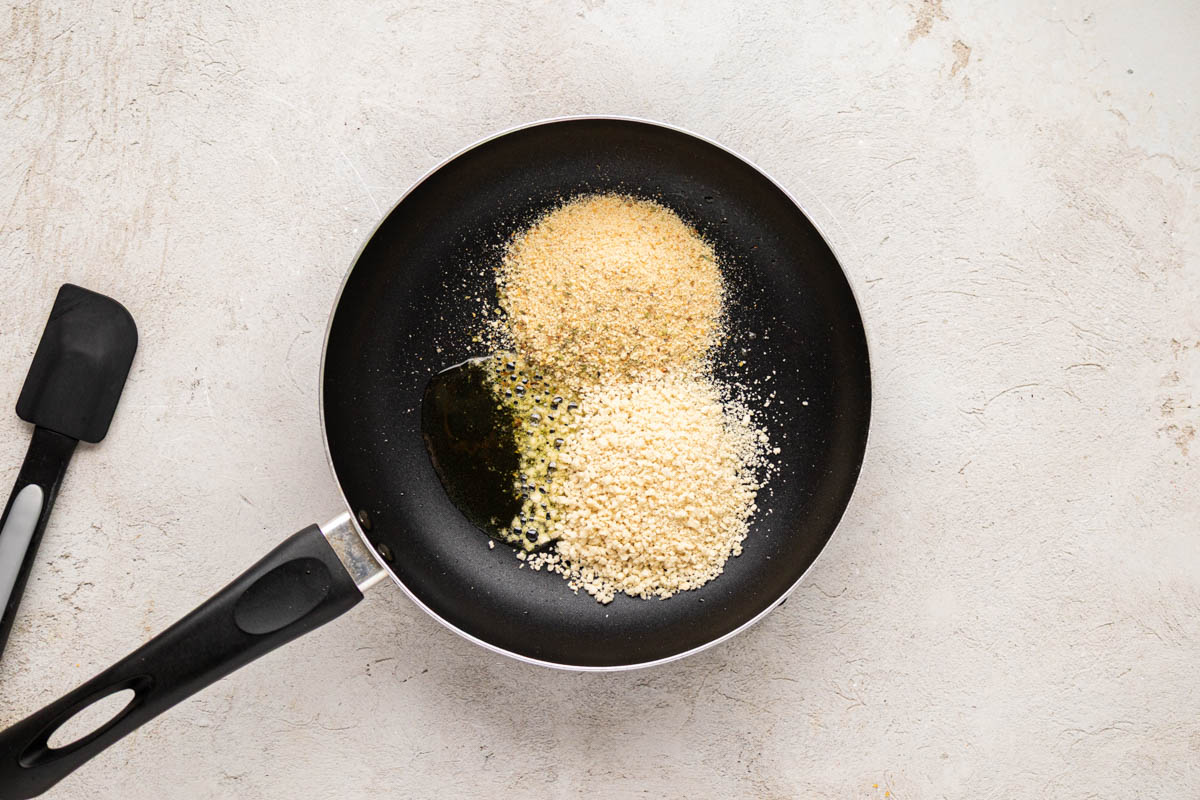 Breadcrumbs, panko crumbs and melted butter in a skillet.