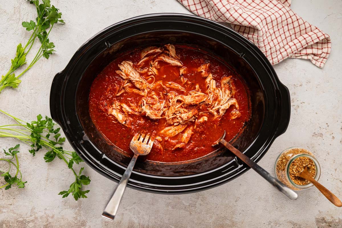 Chicken shredded in the slow cooker.