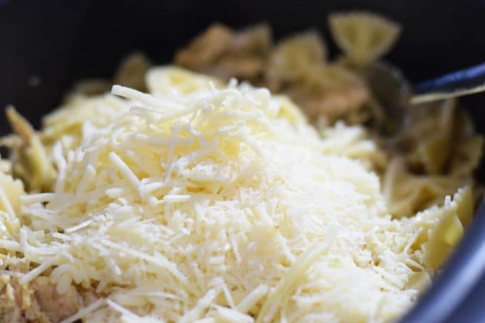 a pile of shredded white cheese to be used in this slow cooker cheesy pesto chicken pasta