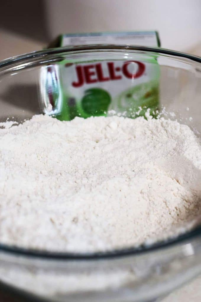 Dry Pistachio Wedding Cookie Ingredients in glass bowl with jello pudding in background