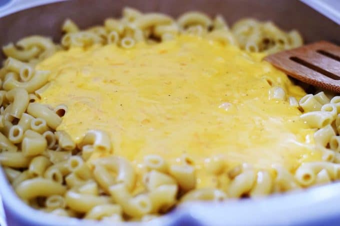 A closeup of elbow macaroni noodles with homemade cheese sauce for this baked macaroni and cheese recipe