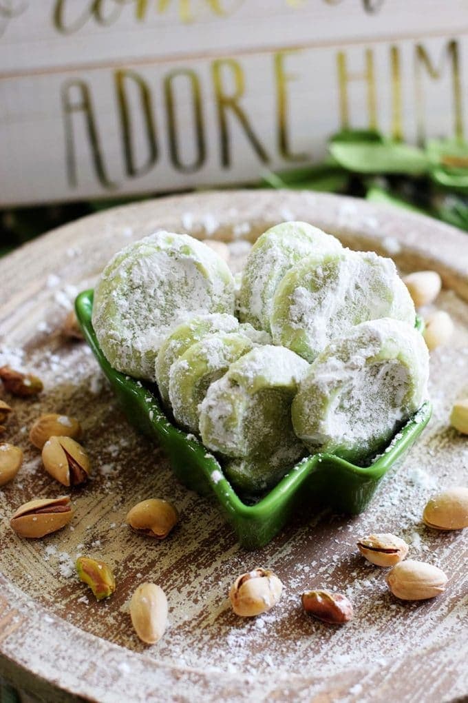 Pistachio Wedding Cookie on tray with pistachios and powdered sugar sprinkled on top