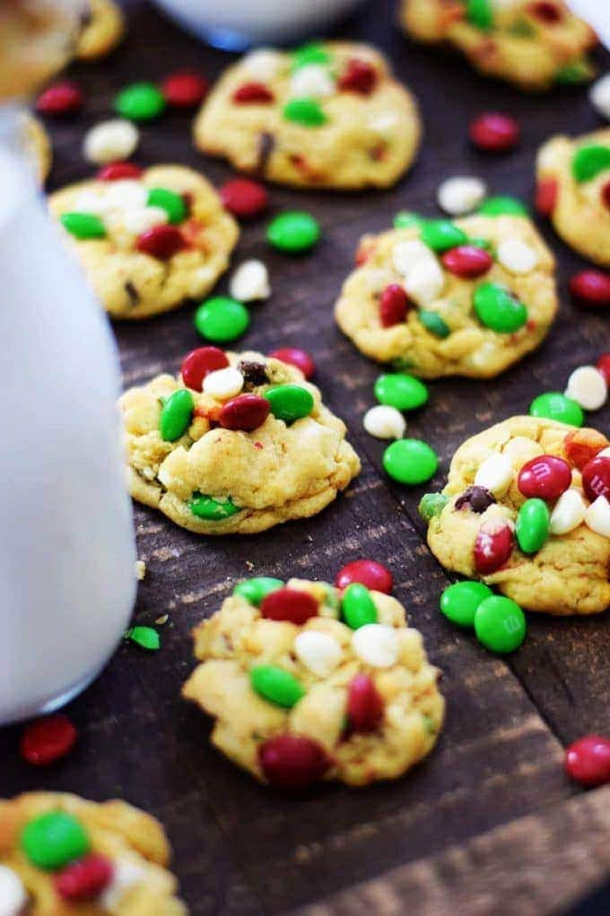 Several Christmas chocolate chip cookies with red, white, and green mini m&m candies, aka Santa\'s chocolate chip cookies