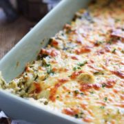 A large white serving dish filled with this Slow Cooker Spinach and Artichoke Dip recipe