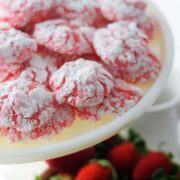 a white serving platter filled with strawberry cake mix cookies aka strawberry crinkle cookies