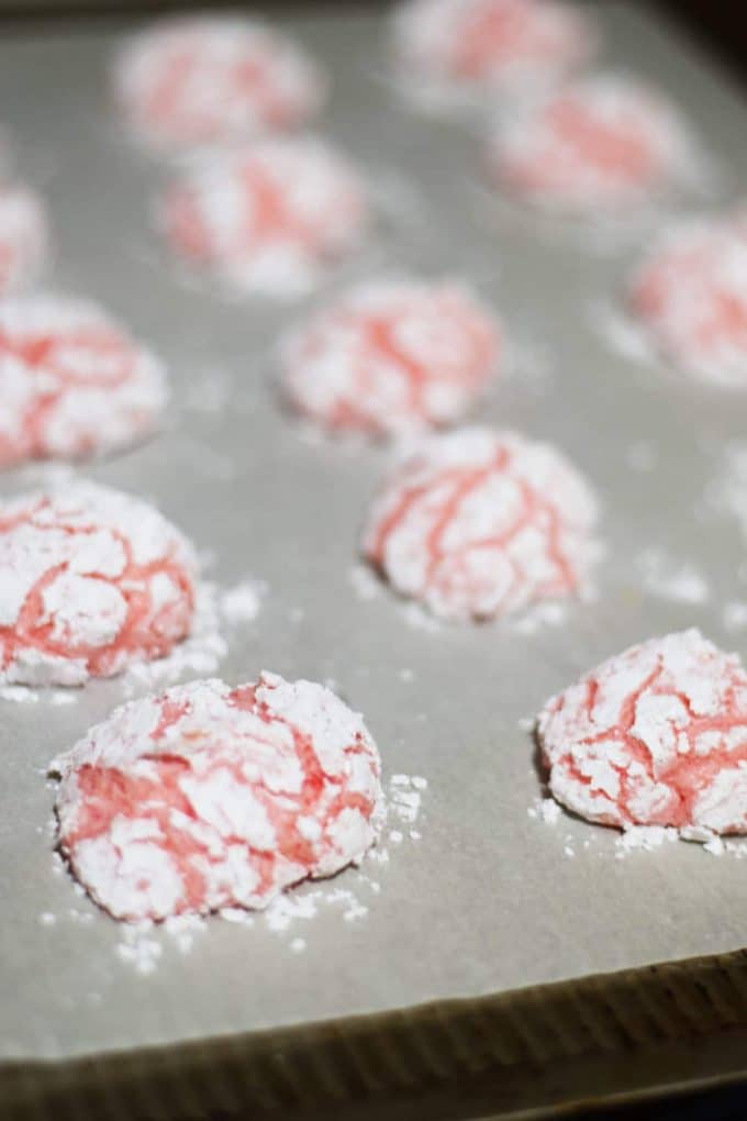 several strawberry cake mix cookies on a baking sheet