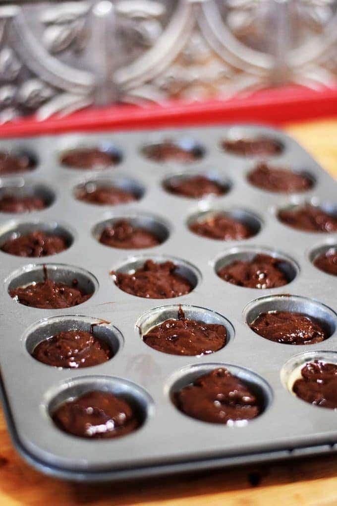 turtle brownie bites ready to be baked in a mini muffin tin
