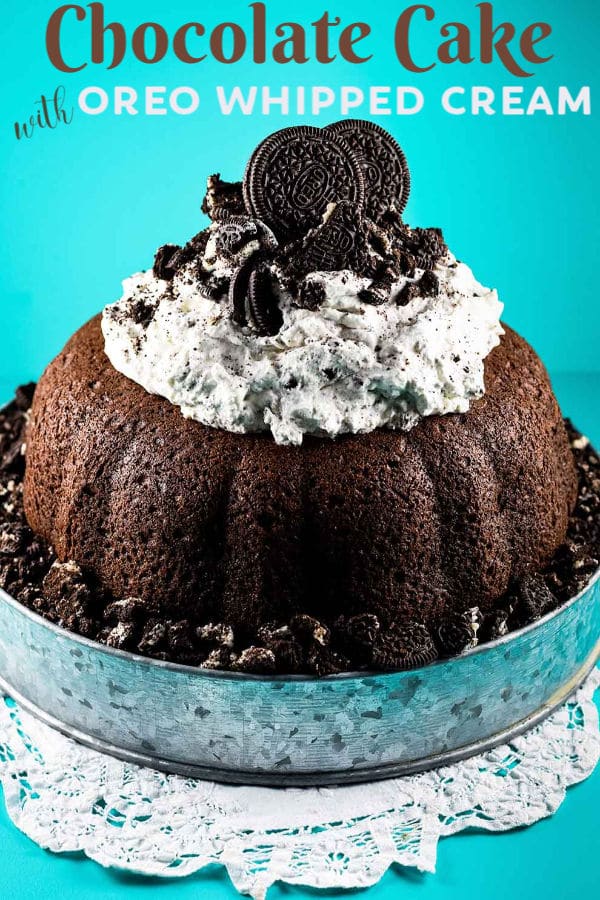 Chocolate Cake with Oreo Whipped Cream on a Rustic Tin Cake Stand on a White Doily