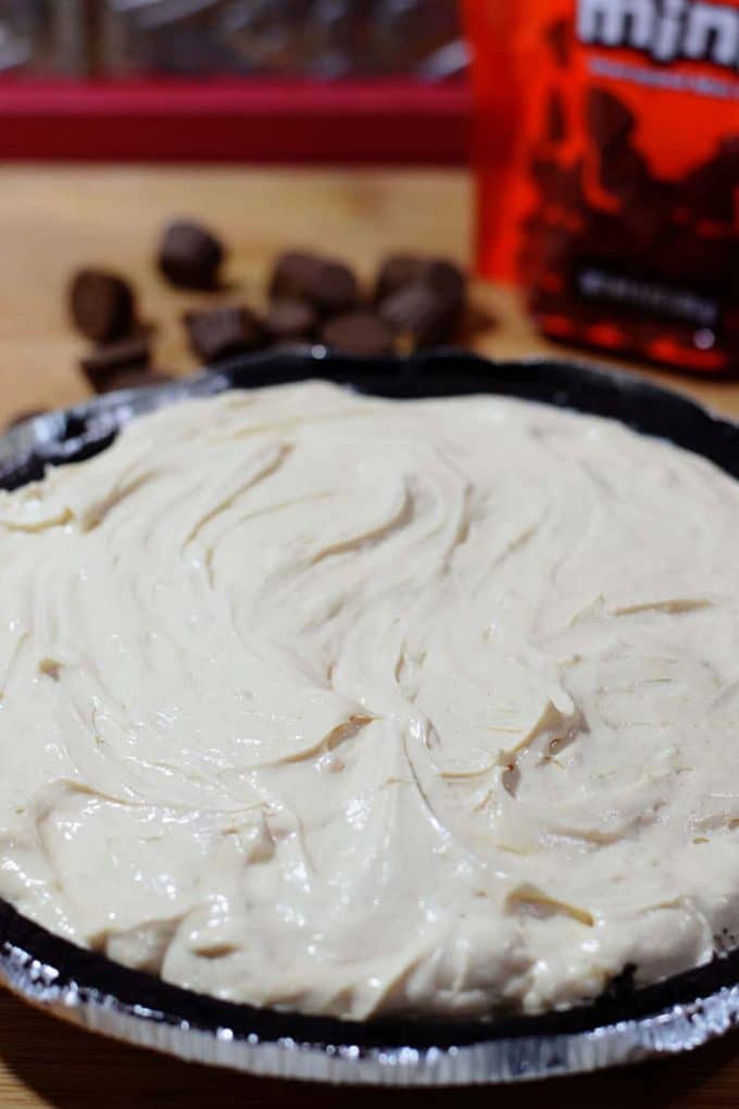 a closeup of this no bake peanut butter cup pie in an oreo pie crust