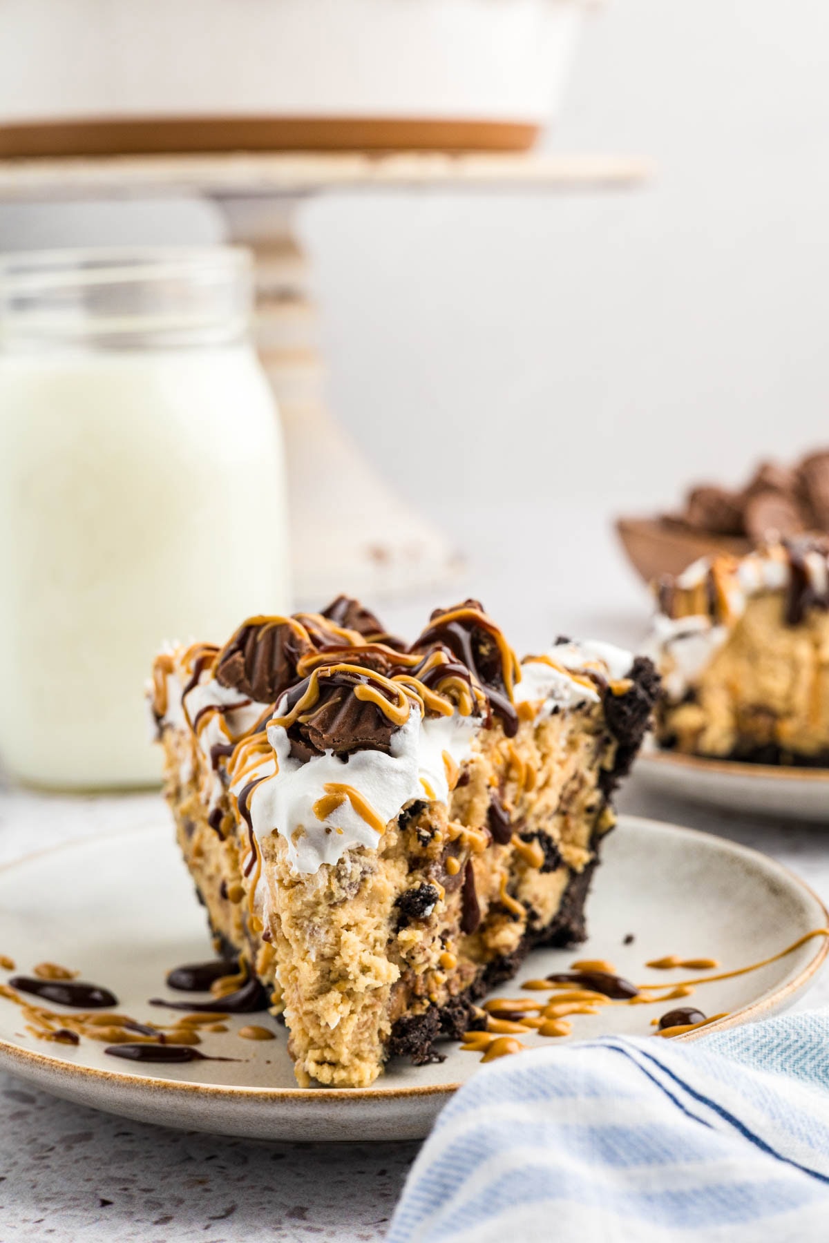 A slice of no-bake peanut butter cup pie on a plate.