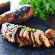 Best Chicken Marinade - Grilled Chicken on a black tray with parsley.