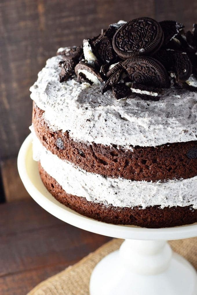 Chocolate Layer Cake with Whipped Oreo Icing on a white cake stand
