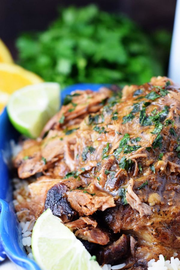 Cuban Mojo Pork Roast topped with thicken marinade gravy and parsley