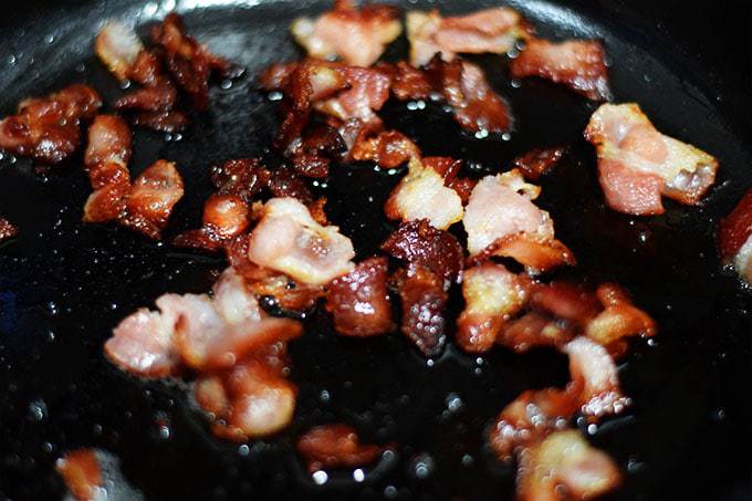 chopped bacon browned in a black cast iron skillet for southern style green beans