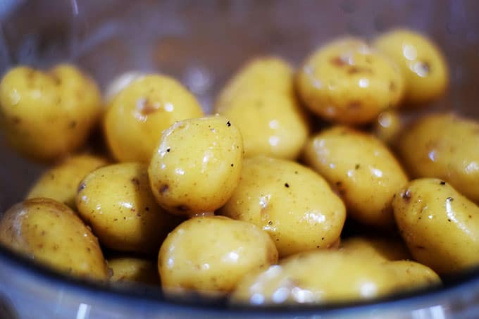a bowl of baby potatoes in lemon dressing