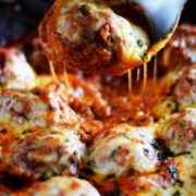 Cheesy Meatballs and Marinara in a cast iron skillet.