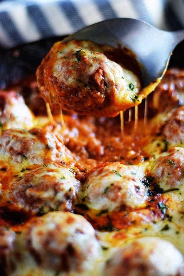 Cheesy Meatballs and Marinara in a cast iron skillet.