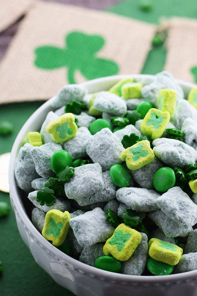 St Patrick's Day Lucky Chow - A bowl of Chex Cereal Tossed in a candy coating mixed with peanut butter and coated in powdered sugar
