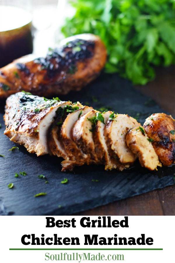 a side view of the best grilled chicken breast with the best grilled chicken marinade sliced thinly, slightly charred, and garnished with chopped parsley