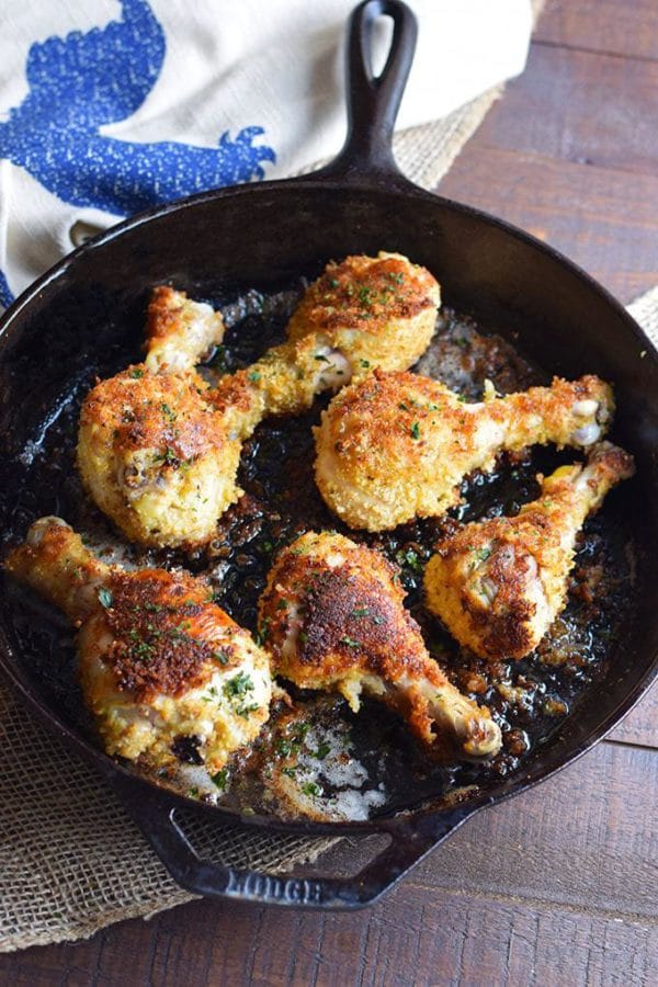 Oven Fried Chicken Legs in a cast iron skillet cooked in butter.