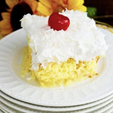 Slice of Pina Colada Poke Cake on white plate