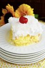Slice of Pina Colada Poke Cake on white plate