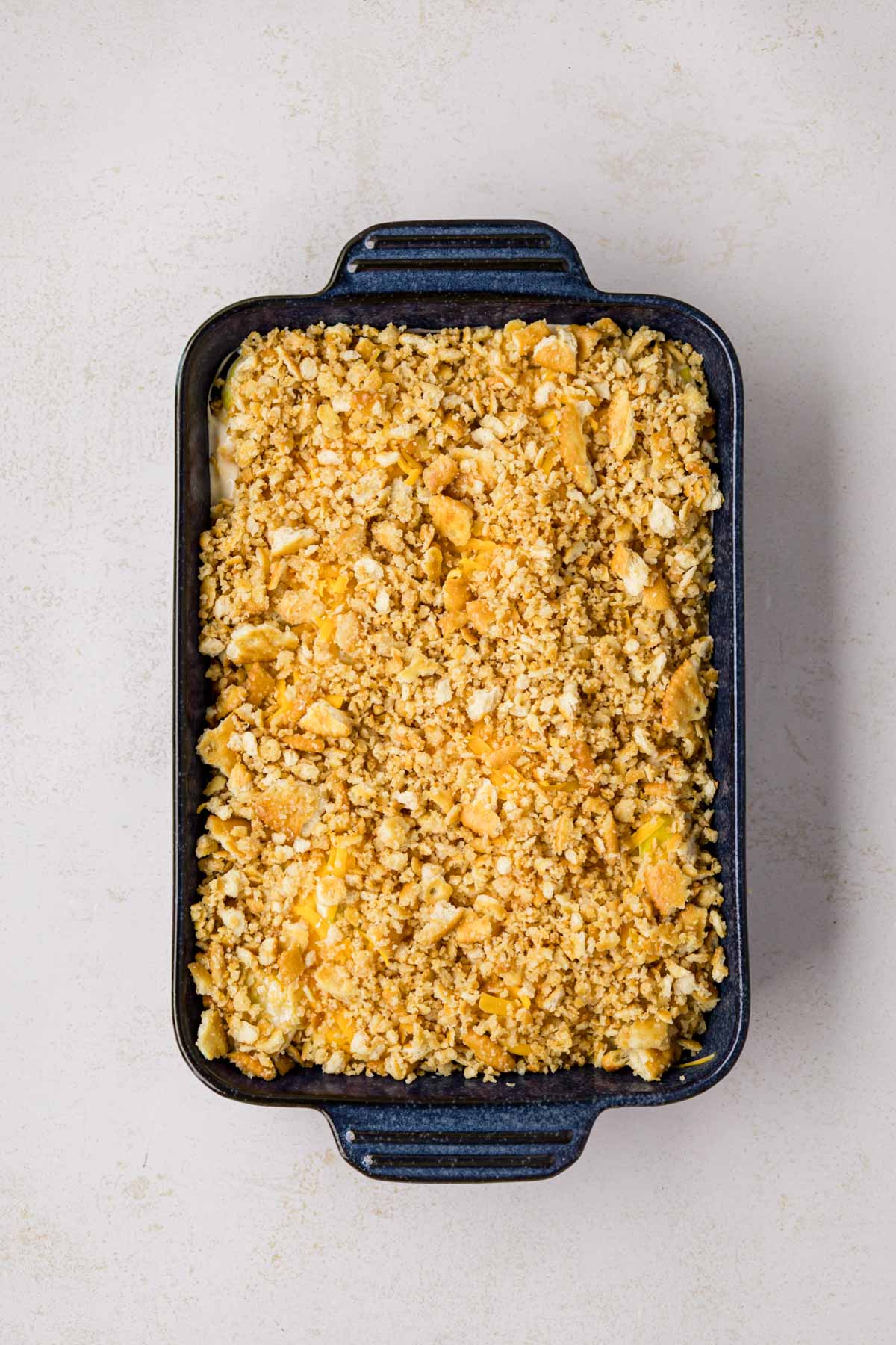 Cracker mixture added to the top of the squash casserole.