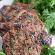 a closeup of these grilled sweet and spicy mustard pork chops garnished with chopped parsley