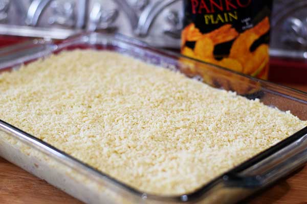 a clear glass casserole dish filled with dry rice for this easy baked chicken and rice casserole