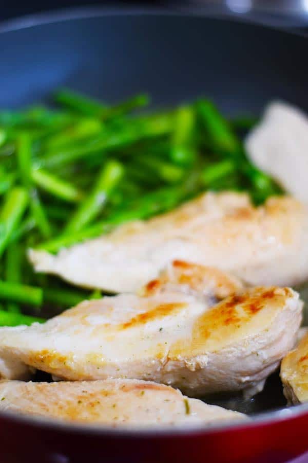 Chicken and Asparagus cooking in a skillet