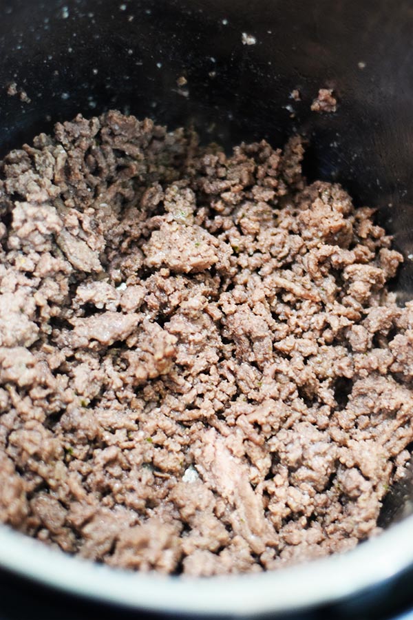 a closeup of browned ground beef in an instant pot to make this instant pot french onion ground beef and noodles recipe