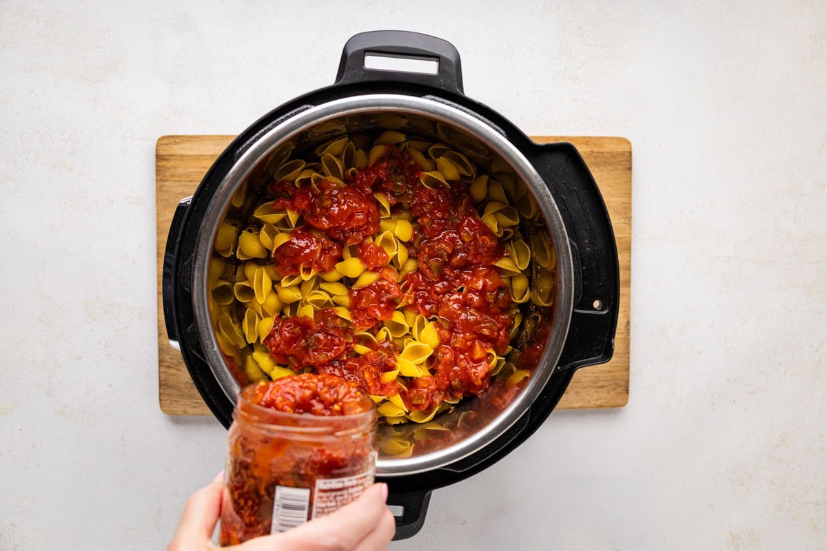 Salsa being poured in the instant pot.