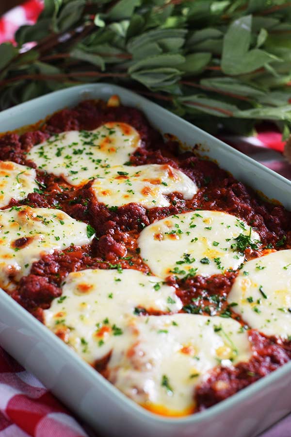 An overhead shot of these baked jumbo shells with melted mozzarella, marinara sauce, and chopped parsley