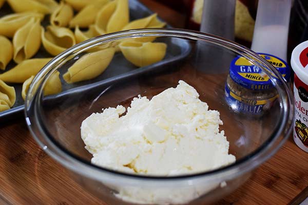 a white bowl filled with ricotta cheese to make this easy baked stuffed shells recipe