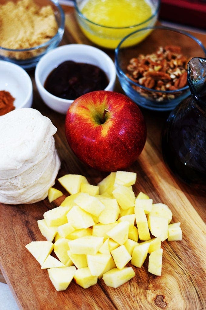 the ingredients for this apple pecan sticky bun bites like biscuit dough, diced apple, pecans, and sugar