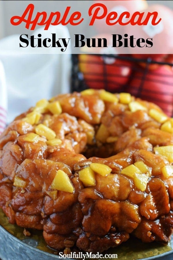 An overhead shot of this apple butter pecan sticky bun bites turned out of the bundt pan on a galvanized metal serving platter with a basket of apples in the background