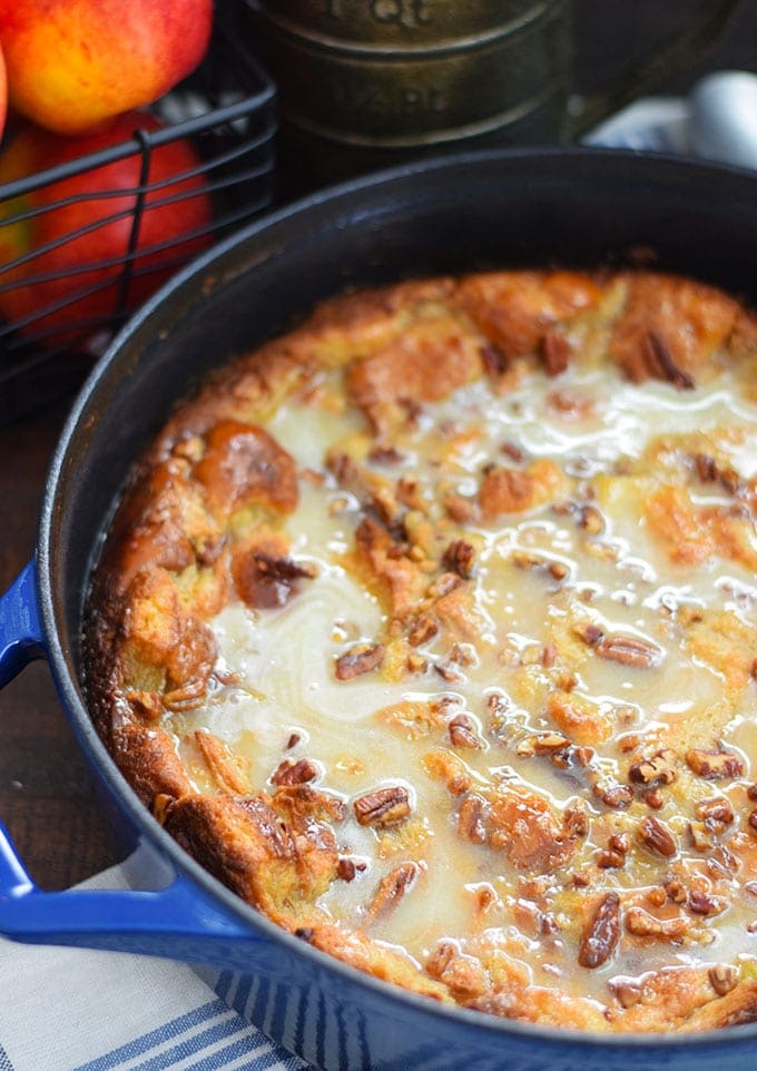 A close up of this bourbon apple pecan bread pudding recipe after it has cooked topped with the glaze