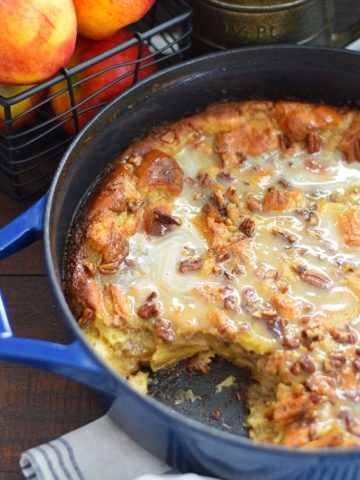 A pot of this bourbon apple pecan bread pudding recipe with a slice missing