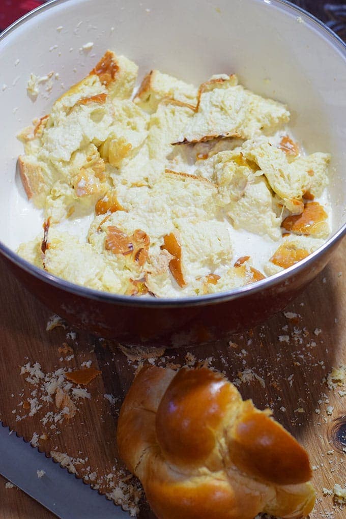 A bowl of torn day-old white bread cubes for this bourbon apple pecan bread pudding recipe