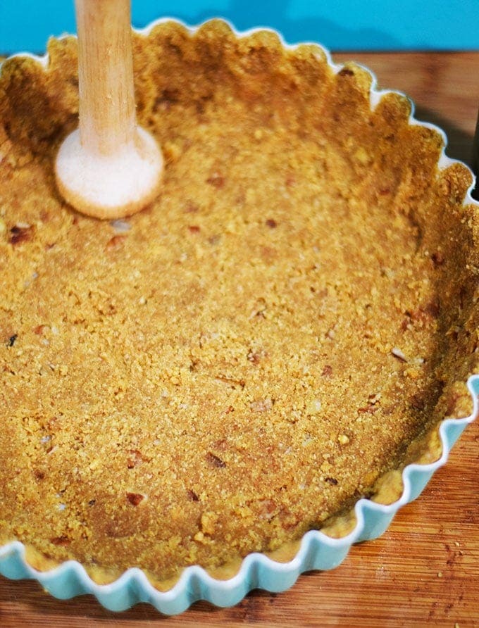 An overhead view of the cinnamon graham cracker crust for this apple butter cheesecake tart recipe