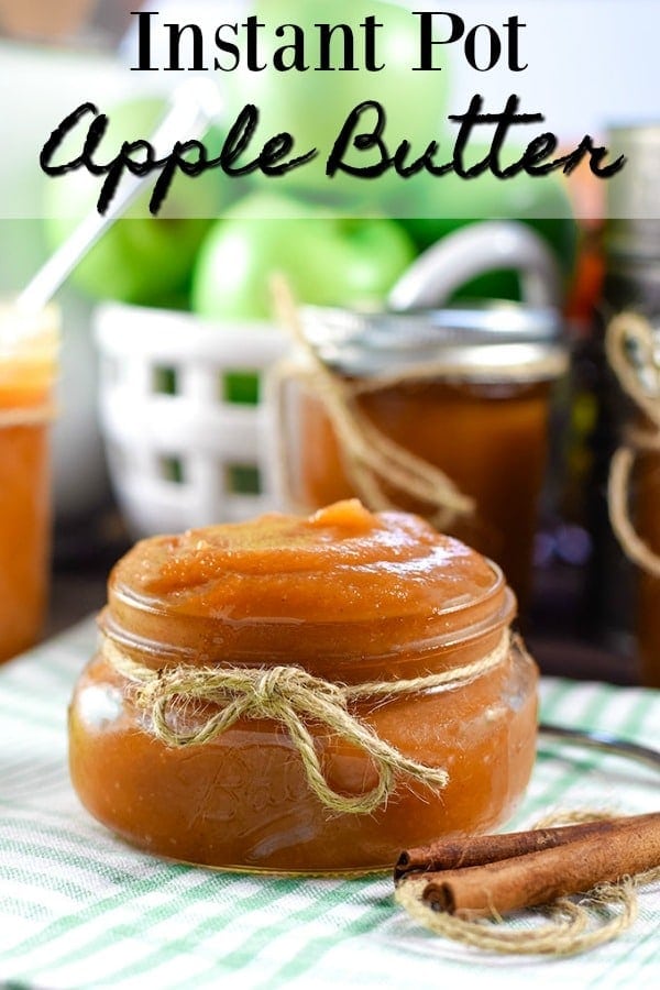 A picnic-style table with jars of this instant pot apple butter and slices of toast