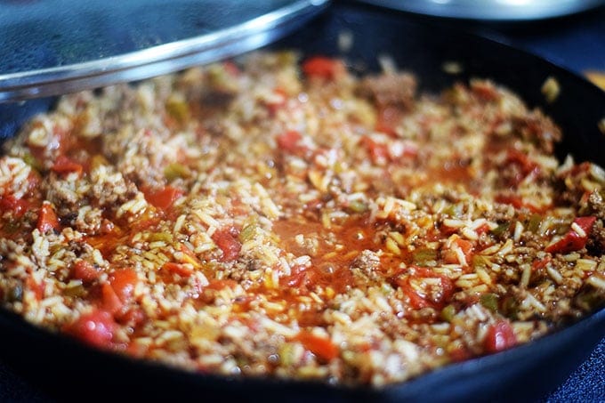 a closeup of this unstuffed pepper skillet before it is baked and before the rice is cooked