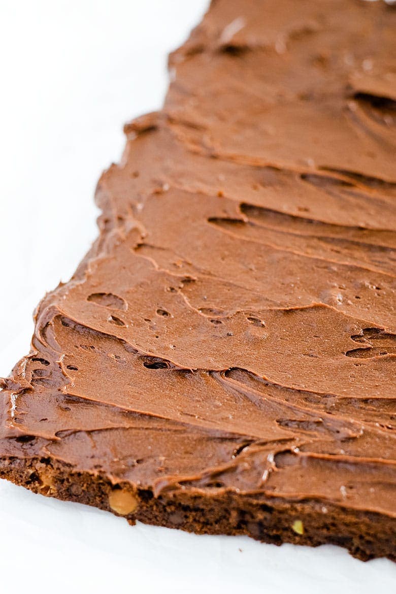 These frosted chocolate turtle brownies before being topped with chocolate chips and chopped pecans